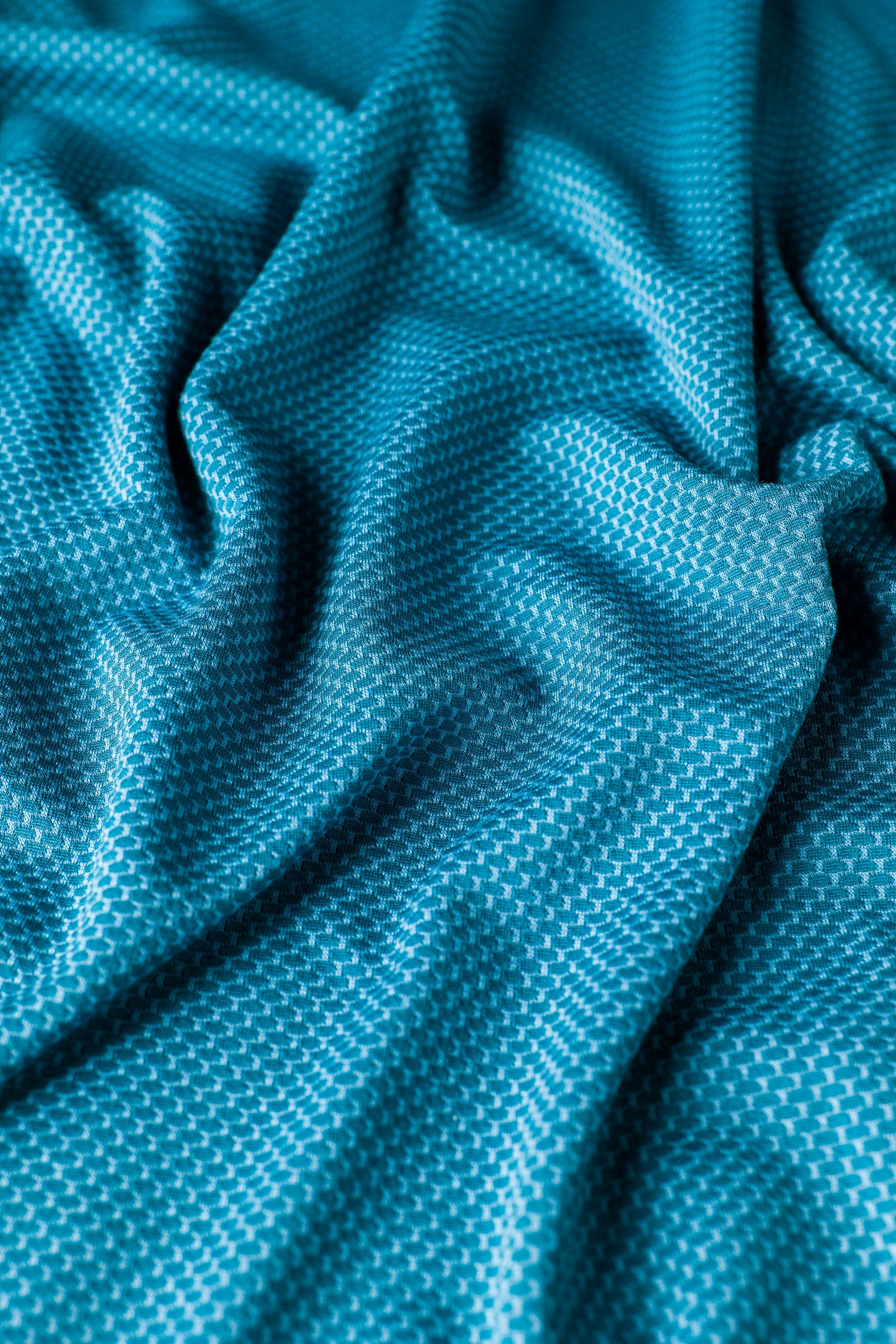 A closeup of the Sunseeker Hoodie in 'Ming Teal.'