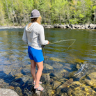 Women's Sunseeker Hoodie in Scallop being worn by a fisher.