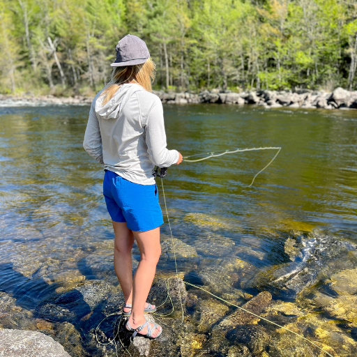 Women's Sunseeker Hoodie in Scallop being worn by a fisher.