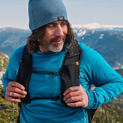 Hiker wearing the Men's Flume Crewneck Baselayer in Crystal Teal.