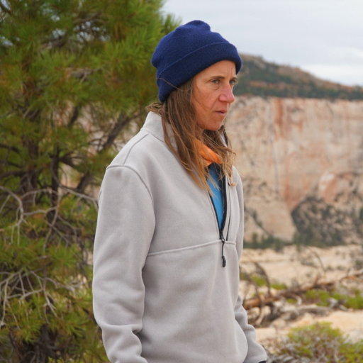 Gray half-zip Women's Campfire Fleece on a female hiker.